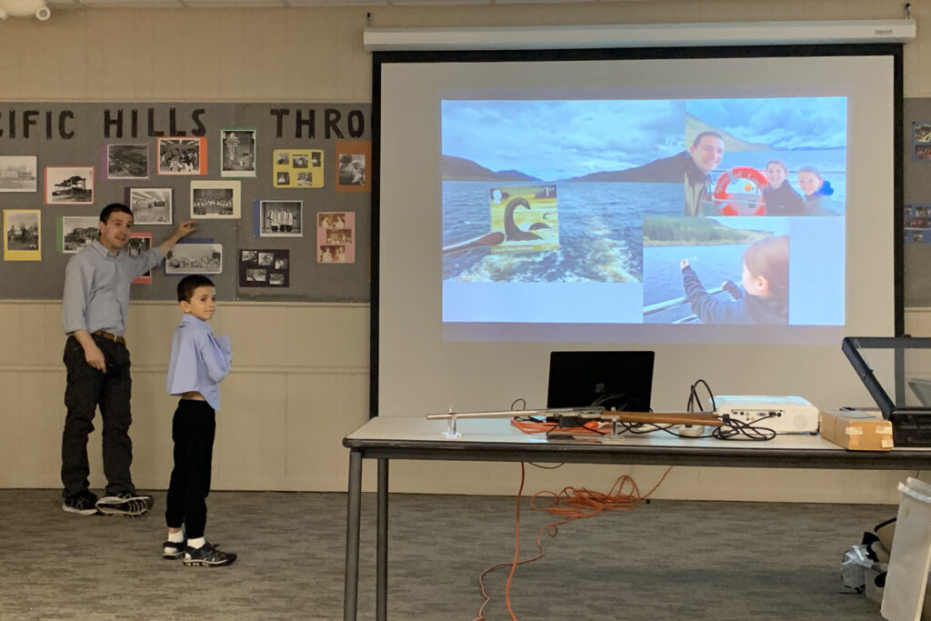 Alex Haimann and his son Winston demonstrate extreme philately at the August 8 Omaha Philatelic Society meeting